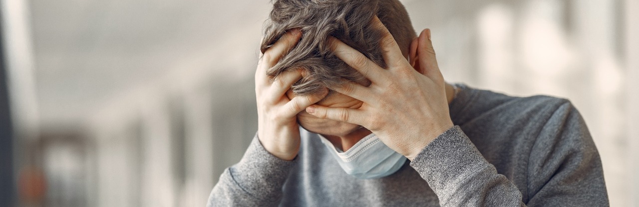 Man in a mask standing in the hall of hospital
