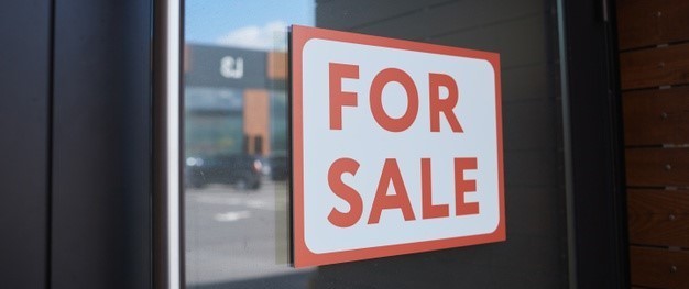 For sale sign outside of building