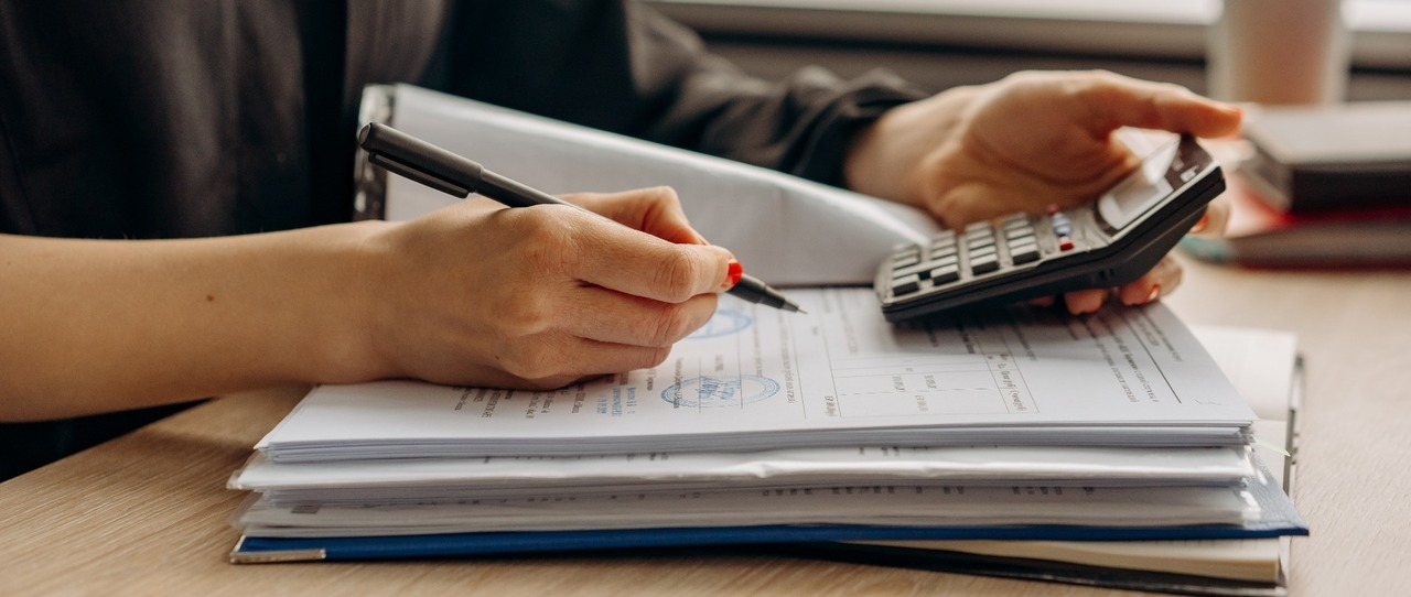 Person going through accounts with a calculator